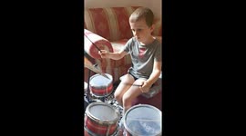 kid playing drum set toy