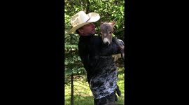 Ohio Rancher singing and rocking his baby donkey.