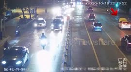 Electric car drives along busy road with bonnet open in southern China