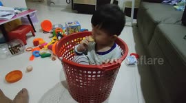 Funny toddler treats the plastic container as his 'Nest'
