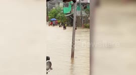 Children Play In Flooded Roads As Tropical Storm Saudel Hits The Philippines