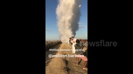 Mesmerizing wedding photoshoot finishes with plane dropping water on newlyweds