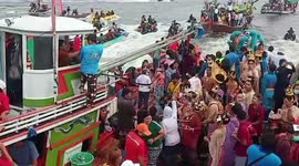 Thousands of Buddhists sail boats in honour of spirt believed to protect fishermen