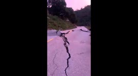 Huge cracks leave road in ruins after flash floods hit Vietnam
