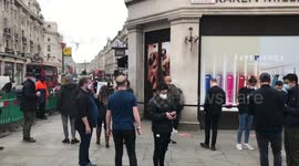 UK customers patiently wait in line to get the new iPhone 12 at Regents Street Apple store