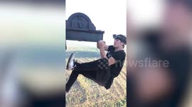 Brit daredevil free climbs one of the tallest power stations in Europe - and even does CHIN-UPS on the side of the 340-metre chimney