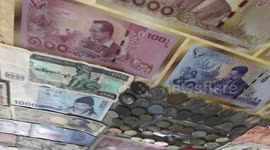Thai taxi driver decorates his cab with money from around the world