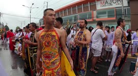 Devotees whip themselves at vegetarian festival in Phuket, Thailand (handheld, FPV, walk around)