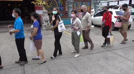 Thai people receiving free food at a temple in Chiang Mai