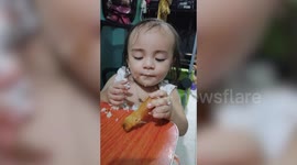 Adorable toddler tries to stay awake while eating food