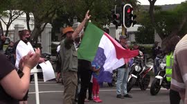 White farmer waves old South African flag during protest against farm murders