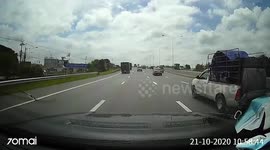Spare wheel comes loose from pickup truck hitting car travelling behind on road in Thailand