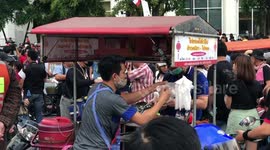 Bangkok food vendors race to feed protesters at march on German embassy