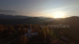 Autumn, sunset, mountains and a church