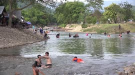 Thai children relaxing in a stream in Thailand.