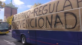 Coach drivers sound horns as they drive through Madrid calling for government aid