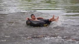 Relaxing on a rubber tube in a stream in Thailand.