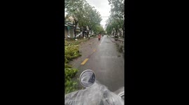 Motorcyclist surveys damage caused by Typhoon Molave in Vietnam