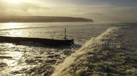 Spectacular Drone Footage of Big Waves Crashing Against Pier