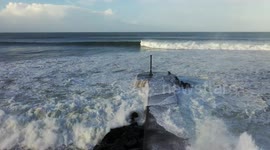 Waves crash over Northern Irish pier during North Atlantic storm surge