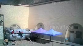 Bus carrying passengers crashes off highway embankment, injuring 13 in northwestern China