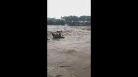 The running water Coils over the bridge like a big wave after the Molave storm hit mainland Vietnam