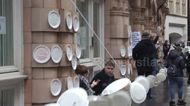 Protesters stick empty plates to the Department for Education demanding free school meals extension