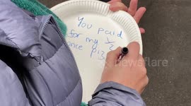 Activists covered Department of Education with empty plates protesting British government's school meals decision