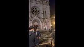People of Nice gather outside the church in leaden silence