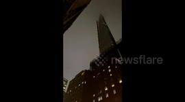 Crane dangerously dangles near high-rise building in NYC amid heavy winds