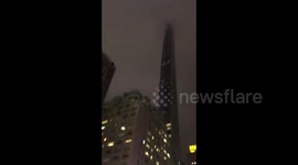 Debris falls from New York skyscraper as winds spin crane around