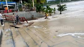 Man rescues girl swept away by sea wave during Typhoon Molave in China