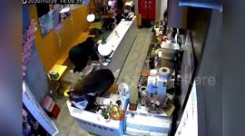 Chinese shop assistant jumps over counter to escape intruding wild boar