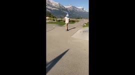Father skates around scenic park in France with son on his shoulders