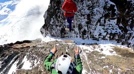 Vertigo inducing video shows base jumpers ascending perilous iron staircase on mountain range in Switzerland