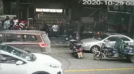 Passersby lift up billboard to free elderly woman trapped underneath in southern China
