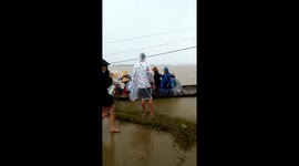 Due to isolation, Dozens of people in a small boat crossed the deep-watered sea to receive relief goods after the Molave storm in Vietnam