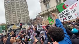 Muslim protesters burn pictures of Emmanuel Macron outside the French embassy in London