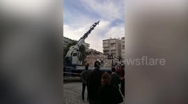 Rescuers search through rubble of collapsed building after earthquake strikes Turkey's coast