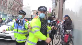Arrests as anti-Macron fury rages outside French Embassy in London, with some burning images of the French president
