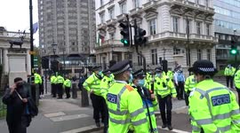 Police disperse Muslim protest outside the French Embassy in London
