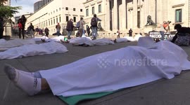 Extinction Rebellion stages die-in outside Spanish parliament in Madrid
