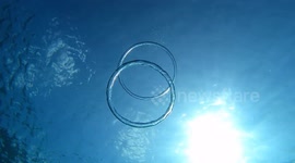 Mesmerising moment two bubble rings colliding in Balearic Islands, Spain