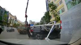 Chinese man luckily survives after lamp post falls from crane and strikes him