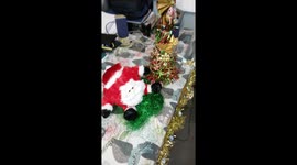 School children can't stop playing with the teacher's laughing Santa Claus bum dancing doll
