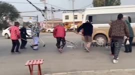 Chinese pensioners use homemade devices to collect coins scattered from hearse