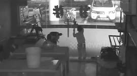 Firemen free boy's head stuck in between glass doors at Chinese shop