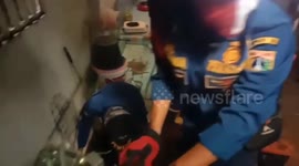 Indonesian firefighters rescue cat that fell down 20-foot-deep well in Jakarta
