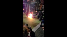 Protesters struggle to burn an American flag during Portland election protest