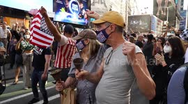 New Yorkers cheer, wave flags, and dance to celebrate the election result